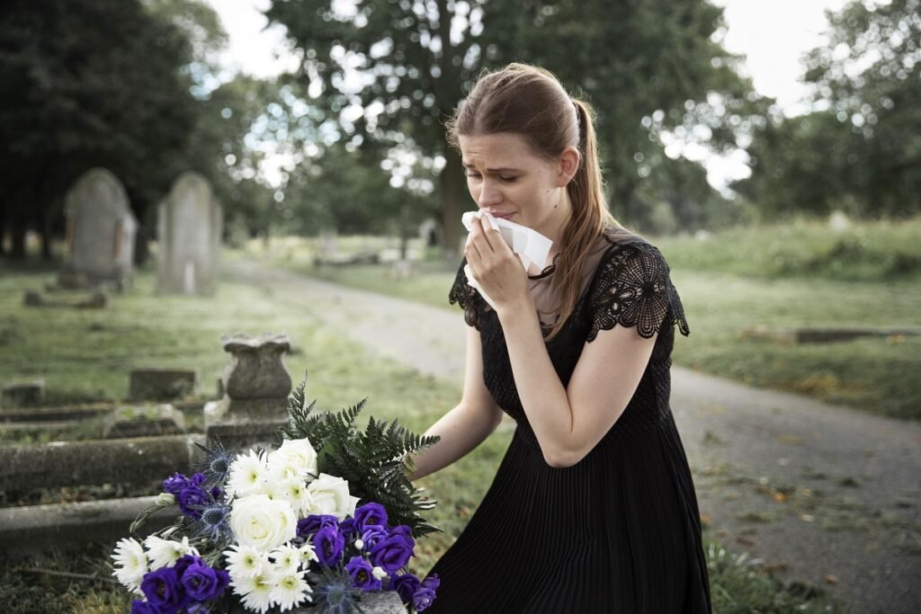 close up woman visiting grave loved one